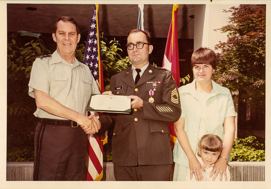 Bill, receiving an award, with Trish and Theresa